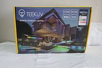 Front of boxed 8-pack TEEKUV RGBCW Hardscape Lighting in original packaging.