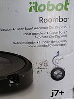 Front of factory-sealed box showing iRobot Roomba branding and model j7+
