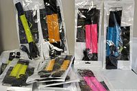 14 pairs of Run Bike Walk bright wrap charge lights in original sealed packaging in orange, bright yellow, pink, and blue colors.