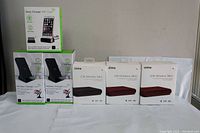 6 boxed wireless charging devices arranged in 2 rows with clear branding and model names visible.