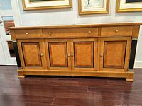 Front elevation showing the full length of the sideboard with its fluted drawer fronts, brass knobs and four panel doors.