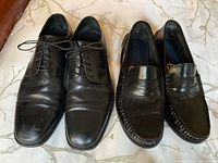 Two pairs of men's black shoes size 11, lace-ups and loafers, shown from top view.