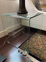 Angled side view showing the folded one-piece glass and waterfall edge design