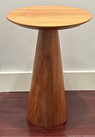 Front view showing round top and tapered base