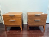 Front view of both teak veneer end tables side by side on hardwood floor