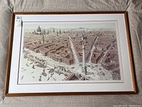 Full view of framed print laid flat on fabric background