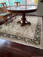 Full view of rug under dining table showing overall design and condition