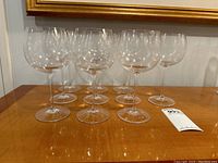 Front view of ten glasses arranged in two rows on a wood surface