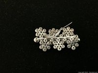 Back view of the silver-tone cluster brooch showing the pin mechanism and Triad marking.