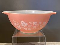 Side profile view of pink Pyrex mixing bowl with white gooseberry pattern.