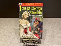 Front cover of the pulp fiction novel showing the book title, author, and illustrated characters.