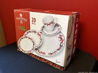 Box showing packaging of Royal Heritage Spirit Of Christmas 20-piece set with photo of dinnerware and holiday design.