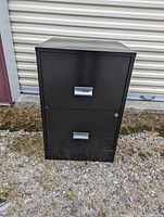 Front view of the black 2 drawer filing cabinet showing handles and lock on top drawer.
