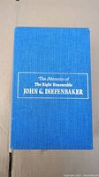 Top view of blue fabric slipcase with title in gold foil: 'The Memoirs of The Right Honourable John G. Diefenbaker'