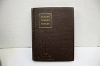 Front cover of Dickens' Pickwick Papers, brown hardcover with gold embossed title and series.