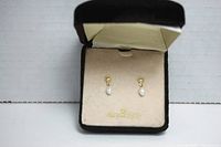 Pair of 10K gold earrings with heart-shaped studs and freshwater pearl drops displayed in a cream fabric-lined box with 10K gold marking.