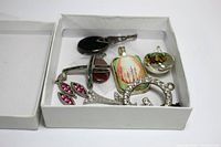 Set of 10 assorted pendants in white box, various shapes and materials including rhinestones, glass and silver