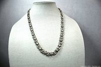 Front view of the necklace on a display bust, showing the full length and design.