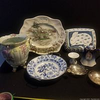 Overall view of vintage china lot including vase, plates, teapot, and silver bowls