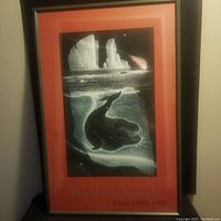 Full view of framed print showing image, red border and black wood frame