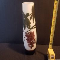 Full view of vase next to measuring tape showing height about 10 inches