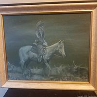 Front view of the large vintage oil painting showing a cowboy on horseback with cattle in the background.