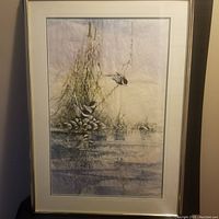 Full view of framed painting showing three birds, pond, and surrounding reeds and rocks.