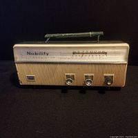 Front view of the Nobility six transistor radio showing tuning dial, knobs, and handle.