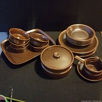 Full set showing bowls, plates, covered casserole, and handled pitcher with saucer.