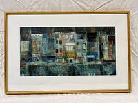 Full frontal photo of the framed abstract cityscape art print showing the entire piece including gold frame and matting.