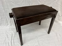 Side and top view of the dark wood piano bench with padded cushion seat showing overall condition and structure.