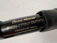 Close-up photo of the rod section showing the label 'Beast Master Fightin' Rod Product of Japan' in gold lettering on a black background.