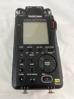 Front view showing LCD screen, control buttons, record button and input level dial