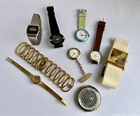 Photo of 9 assorted vintage fashion watches showing variety of styles, bands, and conditions.