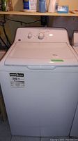 Full view of the GE top loading washing machine showing lid, front panel, and Energy Guide label.