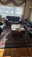 Living room setting showing the large area rug under a coffee table and furniture, illustrating size and usage.