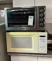 KitchenAid toaster oven stacked on top of Kenmore microwave showing full front view of both appliances.