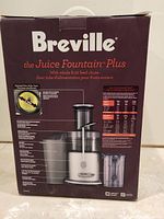 Box showing the name Breville and detailed product image of the Juice Fountain Plus juicer with whole fruit feed chute.