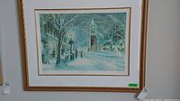 Full view of framed print 'Candlelight Stroll' showing snowy street scene and clock tower.
