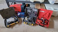 Overview of three hard cases and Bosch box on garage floor