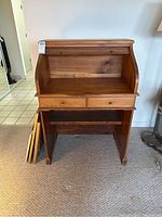 Front view with roll-top retracted showing interior work surface, back panel and two small drawers