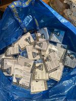 Blue IKEA shopping bag containing 20 individually packaged Ledare LED light bulbs by IKEA.