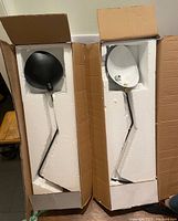 Two lamps in protective foam packaging inside cardboard boxes