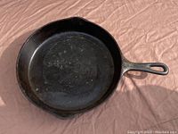 Top view of the 10-inch cast iron skillet showing the cooking surface and handle with hanging hole.