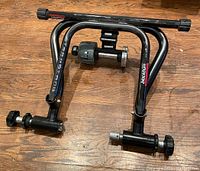 Blackburn Track Stand bike trainer frame showing front view with clamps and resistance unit.