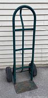 Green Harper Trucks hand truck with P-handle and rubber wheels shown from front and angled front view.