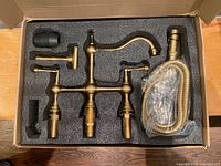 Overall boxed set showing faucet parts neatly fitted in protective foam