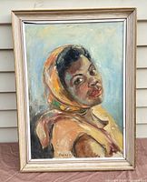 Front view of the framed oil portrait painting showing the subject and artist's signature.