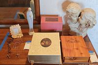 Photo of entire lot on table including large Holy Bible, wooden box Bible, prayer book in box, two statues, rosaries, and framed religious image.