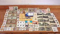 Wide shot of coins, paper money, stamps, tokens, photographs arranged on a wooden surface.